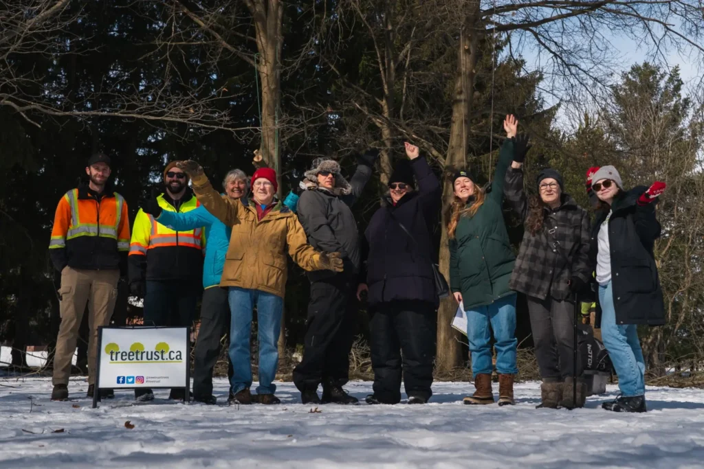 People waving that attended a Tree Trust pruning event at the New Hamburg Arboretum